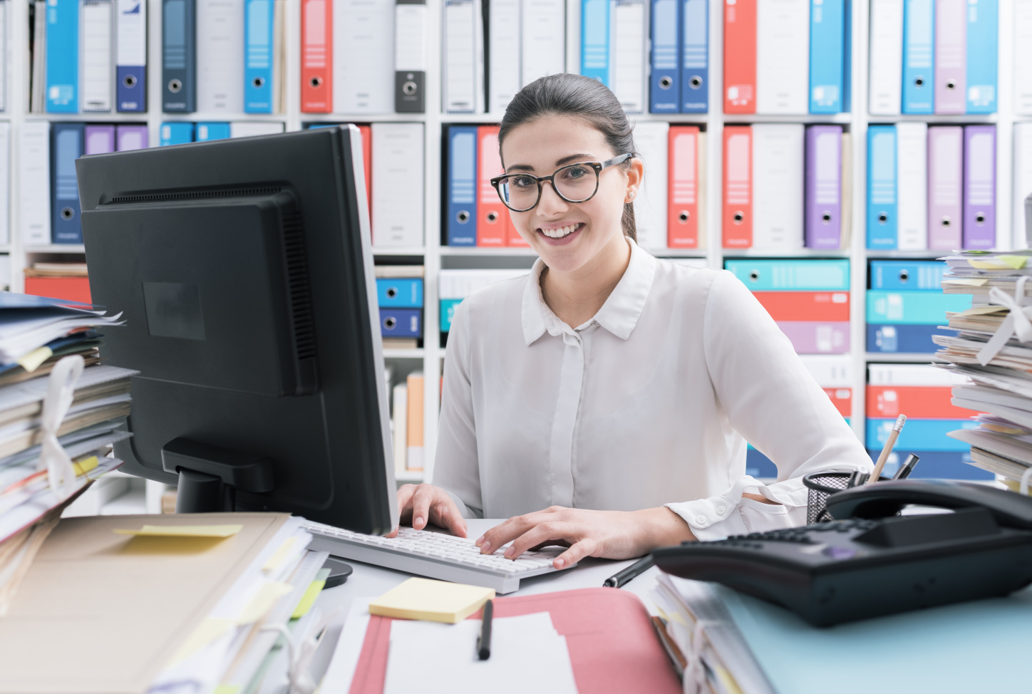 oung secretary working and smiling